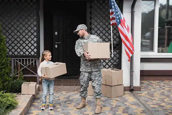 united states military man moving a box with his daughter